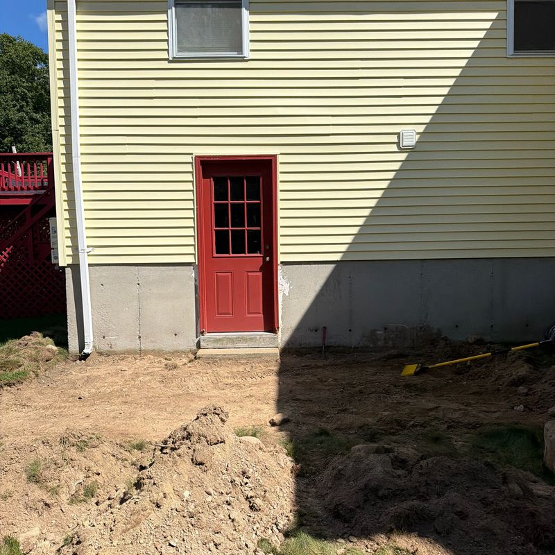 Before: bare ground at the side door